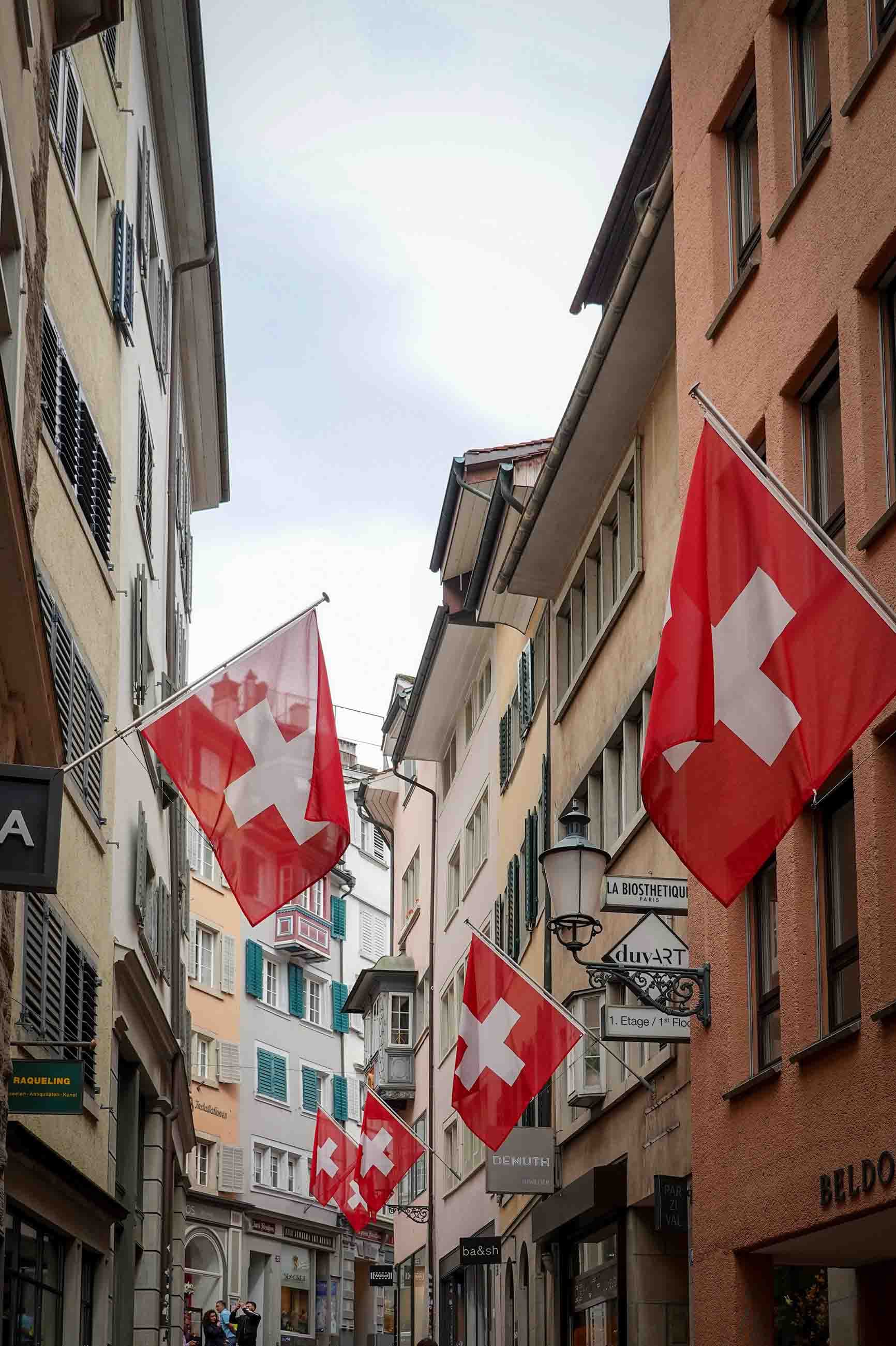 Swiss flags hanging in a Zurich old-town street